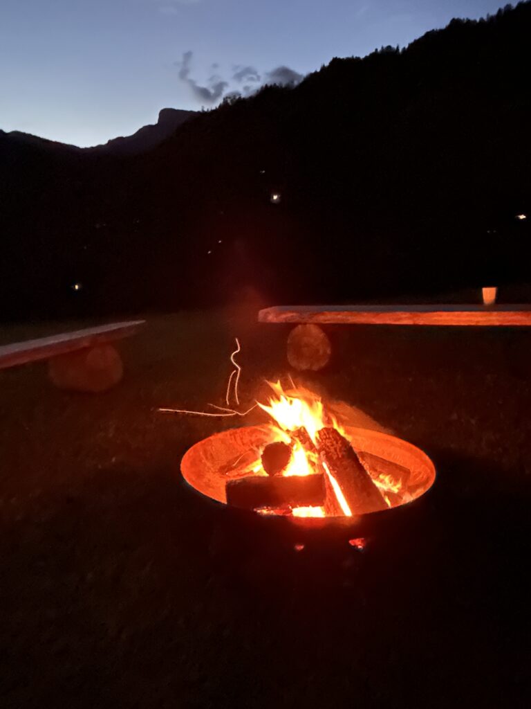 Feu de camp en soirée dans la montagne